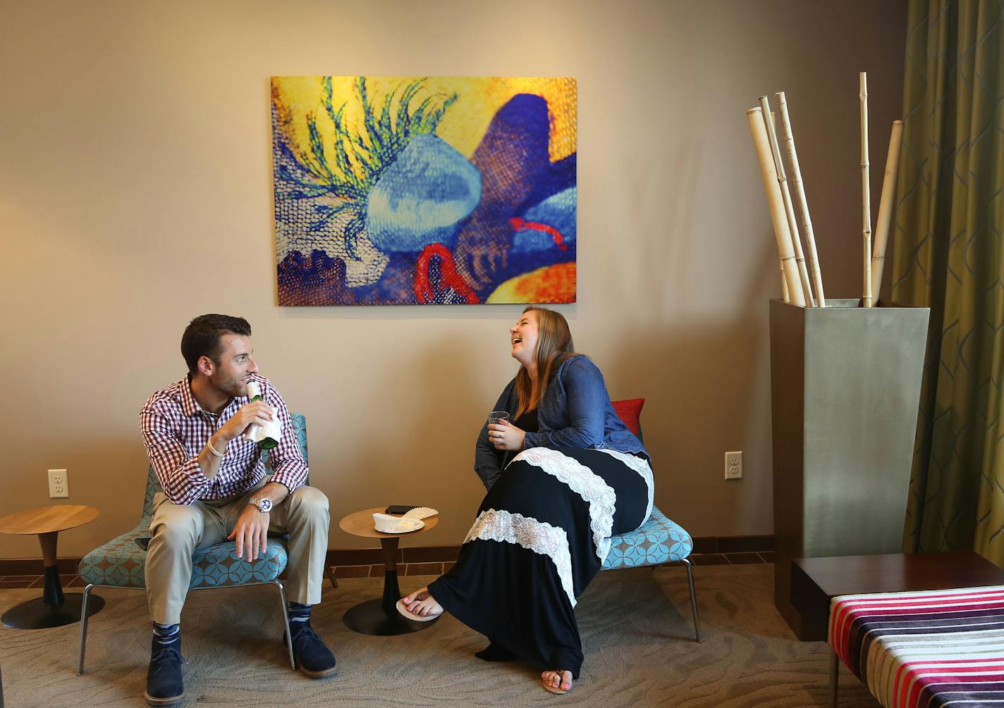 Kevin Kosiek, left, and Bailey Ribich talked during a recent wine-and-cheese gathering at e2 Apartments in St. Louis Park.