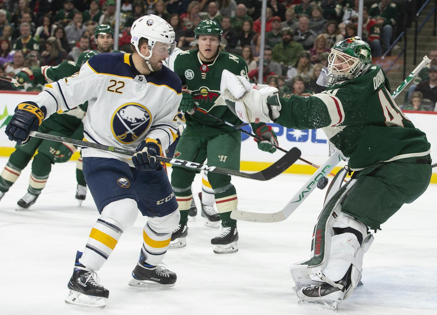 Minnesota Wild goaltender Devan Dubnyk (40) can't control the puck as Buffalo Sabres center Johan Larsson, of Sweden, (22) skates in during the second period of an NHL hockey game Saturday, Nov. 17, 2018, in St. Paul, Minn. The Sabres won 3-2. (AP Photo/Paul Battaglia)