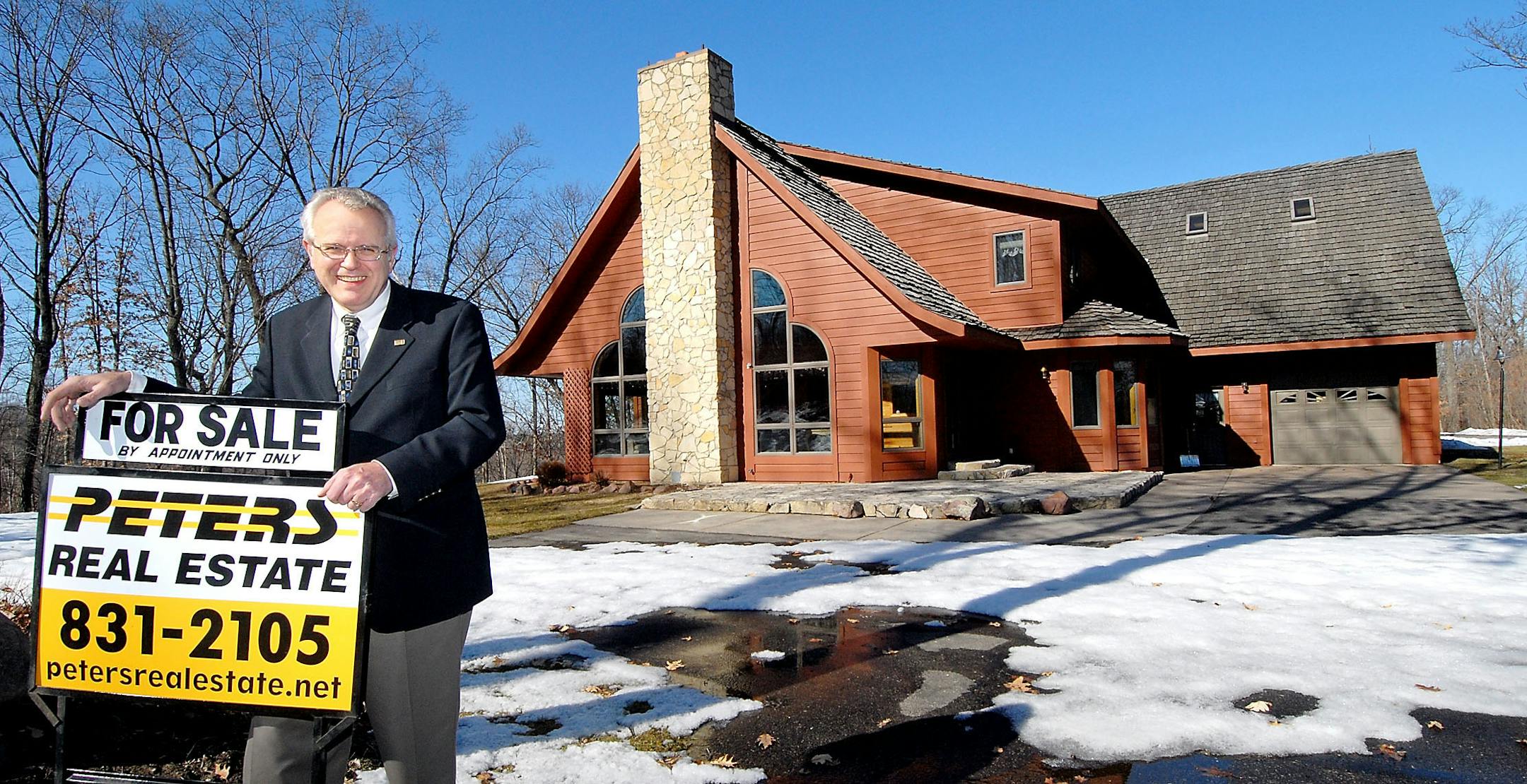 Eau Claire Realtor Wayne Peters showed the home of Bob Fanning, who is selling his rural Whitehall home for $498,900. As an added incentive to a buyer, Fanning is offering a 10-year life insurance policy.