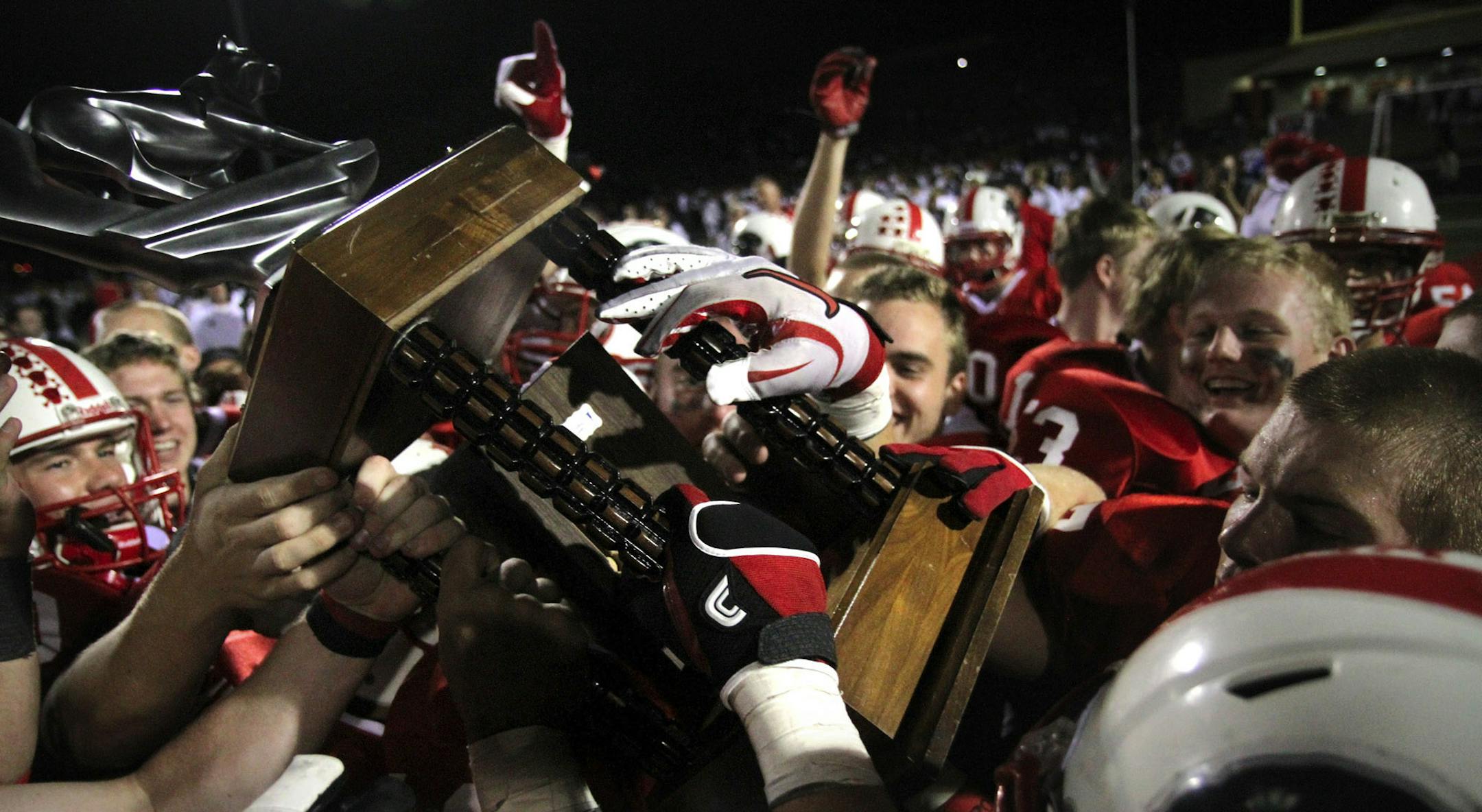 LAKEVILLE MINNESOTA 10/7/2011 The Lakeville North Panthers football team celebrate their 30-6 win over Lakeville South with the One Community Two Cats trophy they will keep for the year Friday October 7, 2011. SPECIAL TO THE STAR TRIBUNE: KATHY M. HELGESON ORG XMIT: MIN2014093015333044