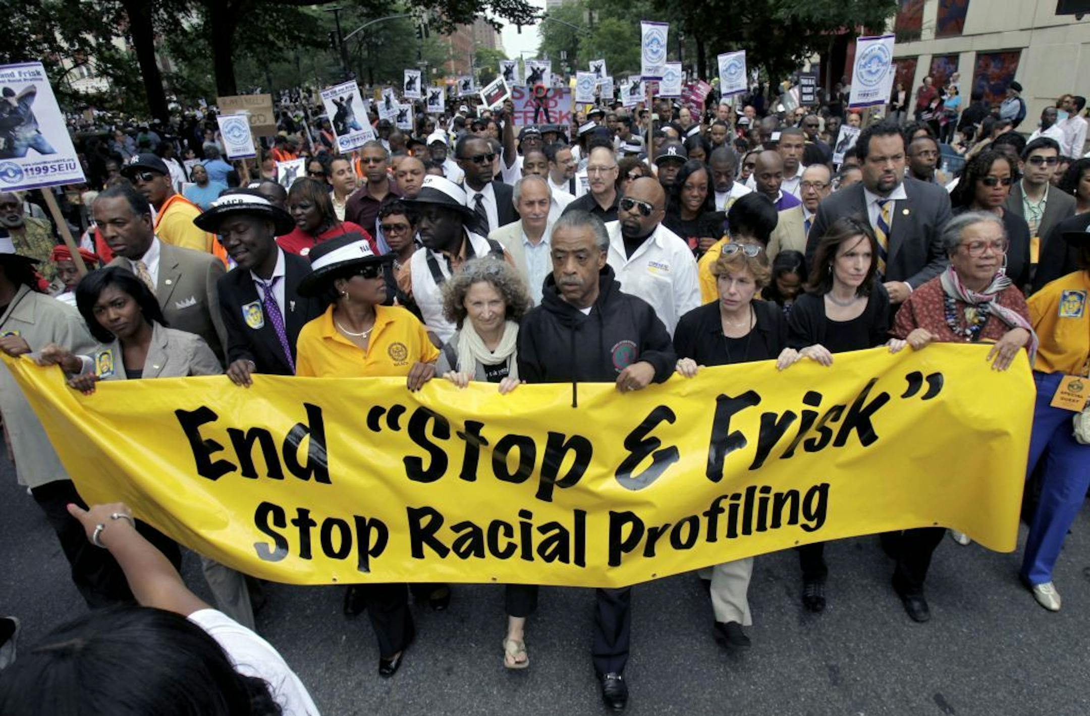 FILE - In this Sunday, June 17, 2012 file photo, Rev. Al Sharpton, center, walks with thousands along Fifth Avenue, during a silent march to end the "stop-and-frisk" program in New York. A federal trial is scheduled to begin in New York on Monday, March 18, 2013, where the NYPD�s practice of stopping, questioning and frisking people on the street will face a sweeping legal challenge. The outcome could bring major changes to the nation's largest police force and could affect how other departments