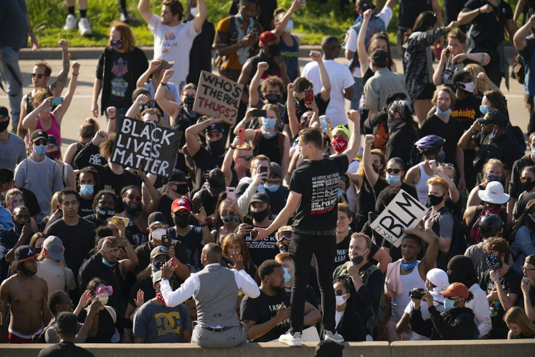 Two men addressed protesters on the south end of the I-35W bridge in Minneapolis on Sunday, May 31, before they began to leave the bridge area.