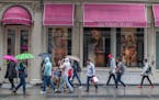 FILE- In this April 4, 2018, file photo, shoppers walk past the Victoria's Secret store on Broadway in the Soho neighborhood of New York. On Monday, A