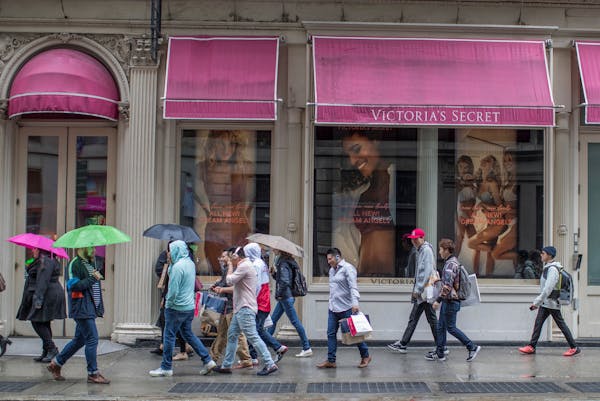FILE- In this April 4, 2018, file photo, shoppers walk past the Victoria's Secret store on Broadway in the Soho neighborhood of New York. On Monday, A