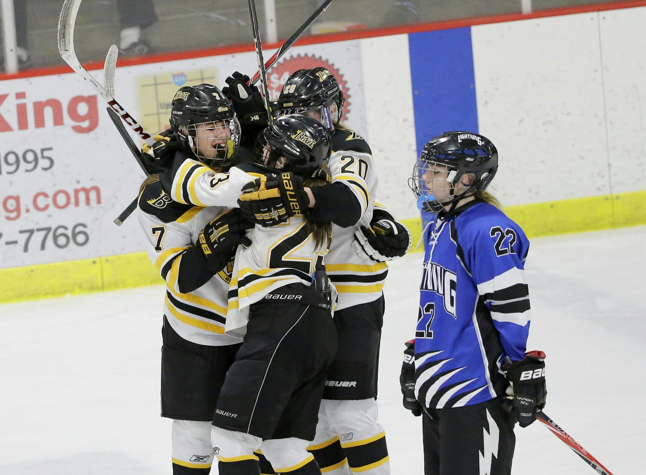 Burnsville's Lindsey Coleman (7) celebrates with teammates after scoring an empty-net goal on Eastview during the third period of a girls hockey, Class 2A, Section 3 section championship game in Inver Grove Heights, Wednesday, Feb. 12, 2014. At right is Eastview's Brooke Pahlen (22). Burnsville beat Eastview 7-4. ( Photo/Ann Heisenfelt) ORG XMIT: puck4