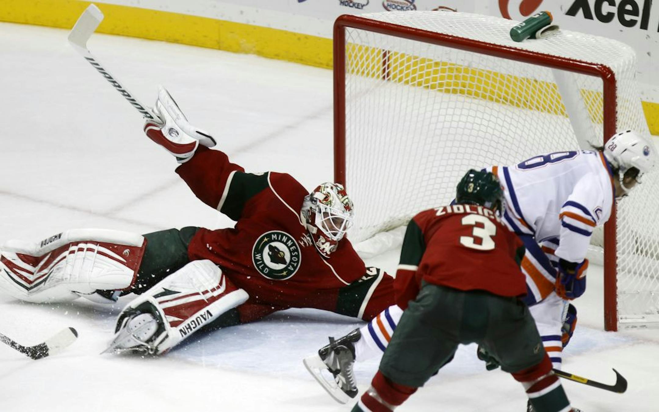 At the Wild game against the Oilers at the Xcel Center in St. Paul, Wild goalie Nicklas Backstrom(32) made a save in the second period against Ryan Jones(28).