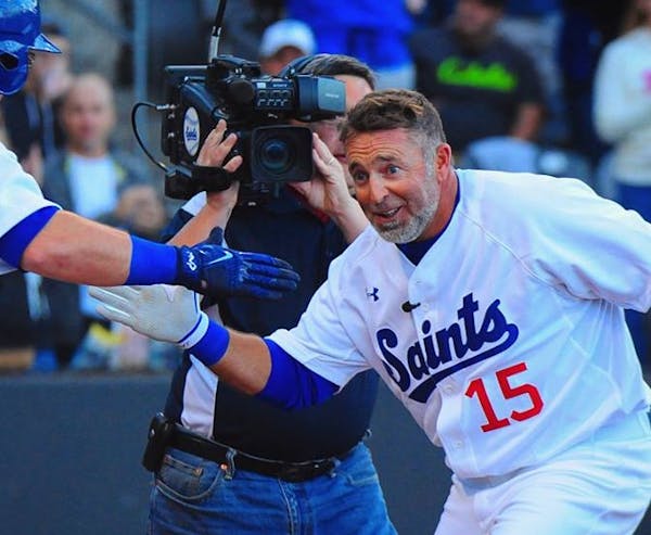 Kevin Millar is greeted at home plate Saturday night after the 45-year-old hit a home run in his lone at-bat for the St. Paul Saints.