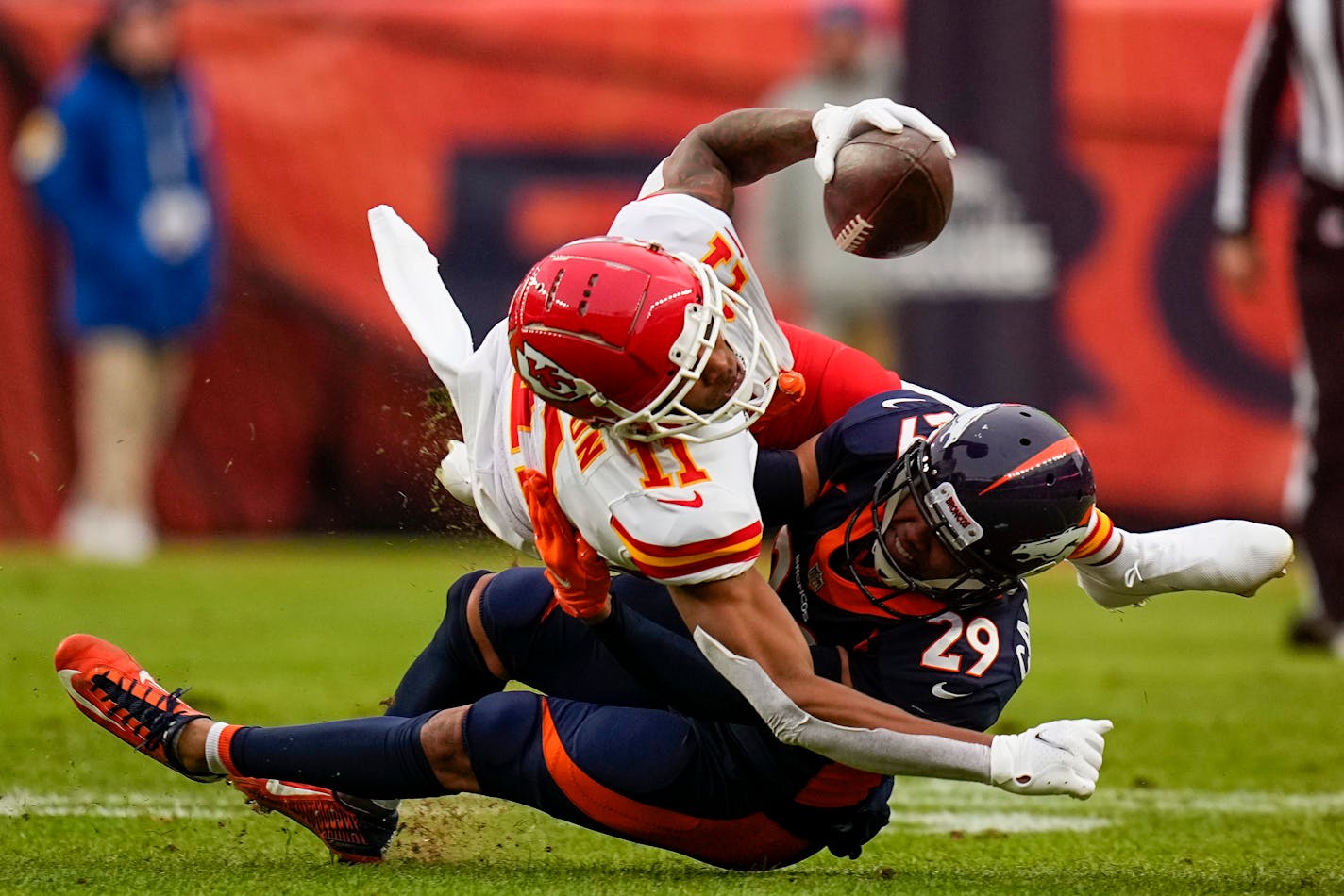 Kansas City Chiefs wide receiver Demarcus Robinson (11) is tackled by Denver Broncos cornerback Bryce Callahan (29) during an NFL football game Saturday, Jan. 8, 2022, in Denver. (AP Photo/Jack Dempsey)