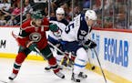 Minnesota Wild left wing Zach Parise (11) and Winnipeg Jets center Mark Scheifele (55) chase the puck during the second period of an NHL preseason hoc