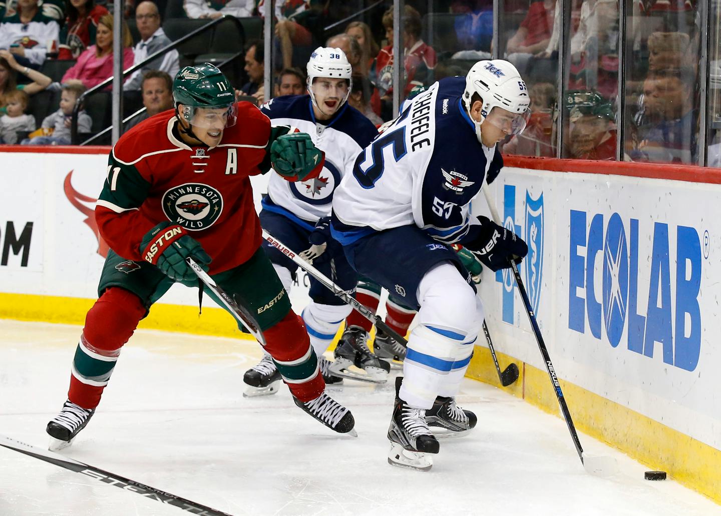 Minnesota Wild left wing Zach Parise (11) and Winnipeg Jets center Mark Scheifele (55) chase the puck during the second period of an NHL preseason hockey game in St. Paul, Minn., Sunday, Sept. 27, 2015.