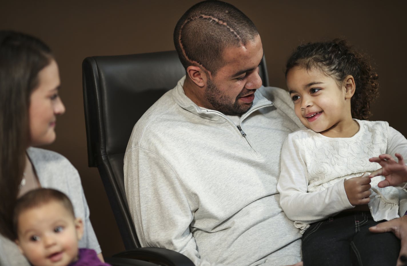 Isaac Kolstad sat with his wife Molly and daughters Malia, 6 mo. and Haidyn,4, (on his lap) in Mankato, Minn. on Wednesday, December 18, 2014. ] REN&#xc9;E JONES SCHNEIDER reneejones@startribune.com Interview with Isaac Kolstad, 24, who survived a beating in downtown Mankato that has lead to charges against former U of M quarterback Philip Nelson.