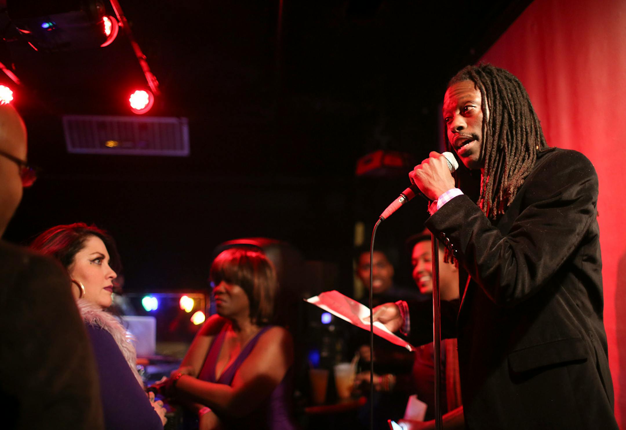 Poet Roger Reeves read one of his poems to kick things off at The Prince Purple Poetry Party Wednesday night at First Ave. ] JEFF WHEELER • jeff.wheeler@startribune.com One of the off-site events at the start of the AWP Conference & Bookfair was The Prince Purple Poetry Party Wednesday night, April 8, 2015 in The Record Room at First Ave. in Minneapolis. More than a dozen poets read poems they wrote that were inspired by the music of Prince.
