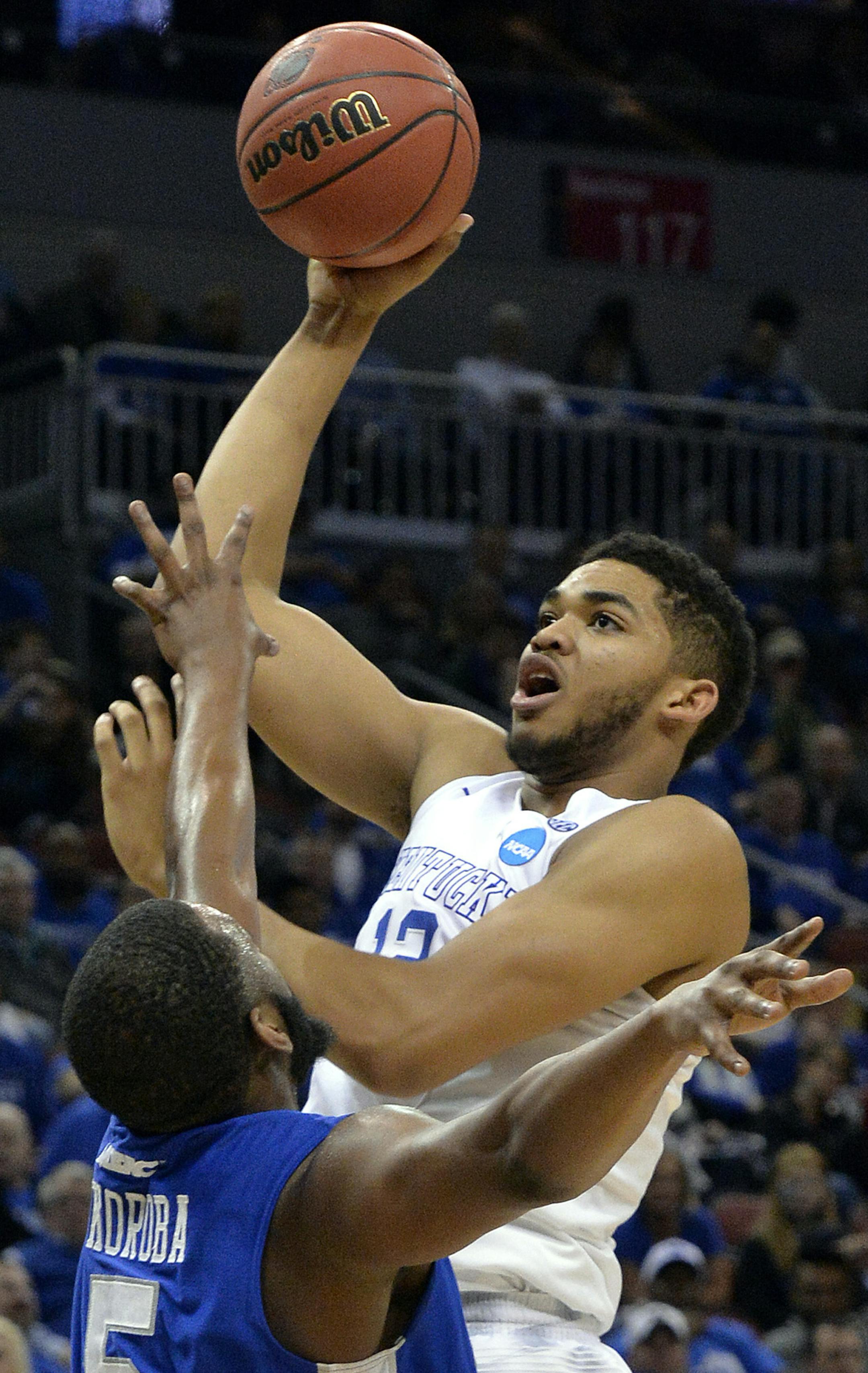 Kentucky's Karl-Anthony Towns, right, shoots over the defense of Hampton's Emmanuel Okoroba during the second half of an NCAA tournament second round college basketball game in Louisville, Ky., Friday March 20, 2015. Kentucky won 79-56. (AP Photo/Timothy D. Easley) ORG XMIT: LOU211