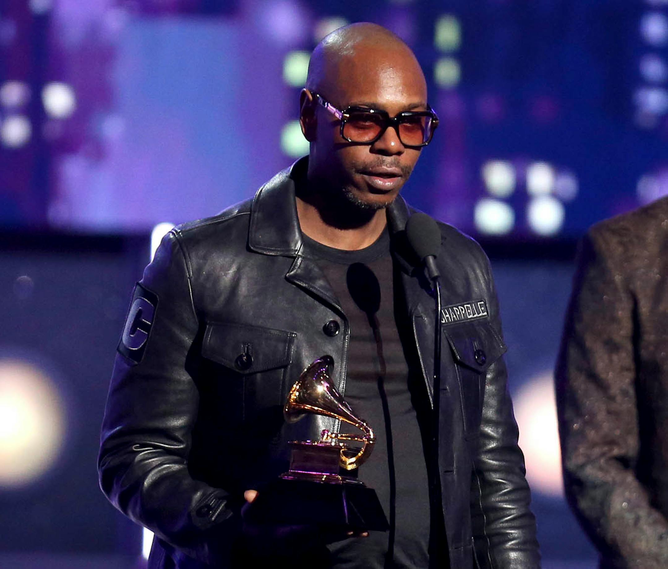 Dave Chappelle accepts the award for best comedy album for "The Age of Spin" and "Deep In The Heart Of Texas" at the 60th annual Grammy Awards at Madison Square Garden on Sunday, Jan. 28, 2018, in New York.
