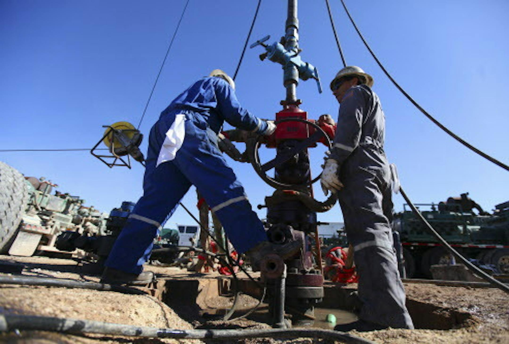 FILE -- PHOTO MOVED IN ADVANCE AND NOT FOR USE - ONLINE OR IN PRINT - BEFORE JAN. 11, 2015. -- Oil field workers for Pioneer Natural Resources standing at a well that was being fracked on the Giddings Estate, an oil field south of Midland, Texas, Feb. 14, 2012. Oil‚Äôs price plunge during the fourth quarter of 2014 hurt energy funds, but investors may still be able to make good bets by focusing on specific pieces of the industry. (Jim Wilson/The New York Times)