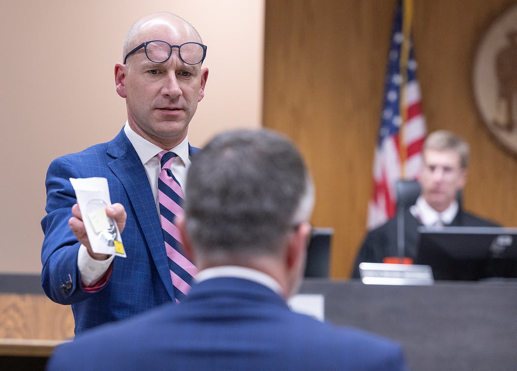 Nicolae Miu’s defense attorney Corey Chirafisi handled evidence during Miu’s trial at the St. Croix County District Court in Hudson on Monday.