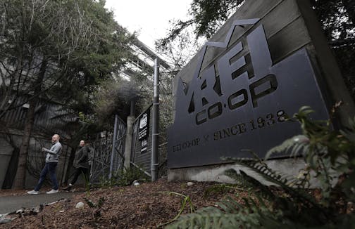 An entrance to the REI flagship store is shown Friday, March 2, 2018, in Seattle. The outdoor retailer says it's halting future orders of some popular brands, including CamelBak water carriers, Giro helmets and Camp Chef stoves, whose parent company also makes ammunition and assault-style rifles. The Seattle-based company has been facing mounting pressure from some customers. (AP Photo/Ted S. Warren)