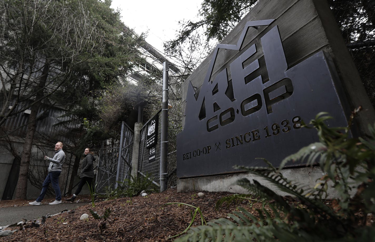 An entrance to the REI flagship store is shown Friday, March 2, 2018, in Seattle. The outdoor retailer says it's halting future orders of some popular brands, including CamelBak water carriers, Giro helmets and Camp Chef stoves, whose parent company also makes ammunition and assault-style rifles. The Seattle-based company has been facing mounting pressure from some customers. (AP Photo/Ted S. Warren)