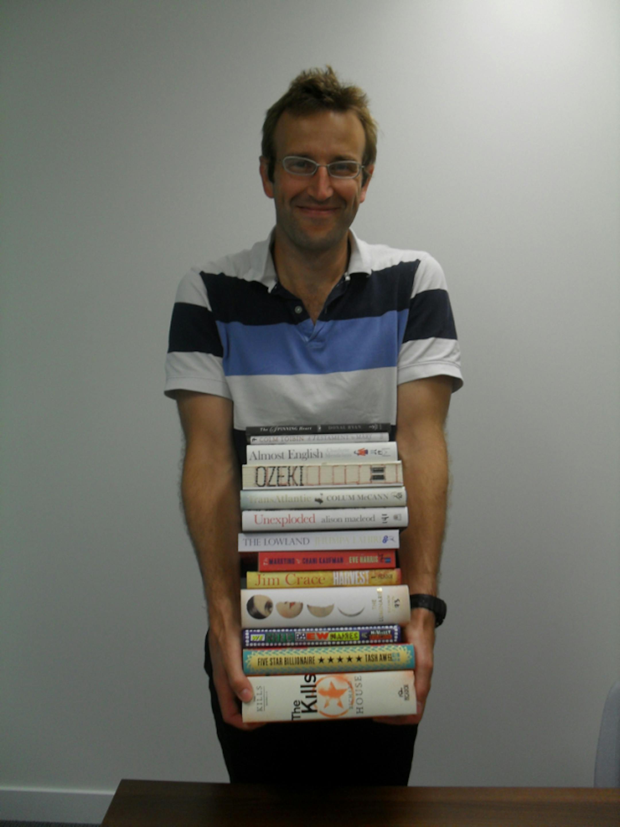 Robert Macfarlane, chairman of the Man Booker Prize committee, shows off the titles of this year's longlist.