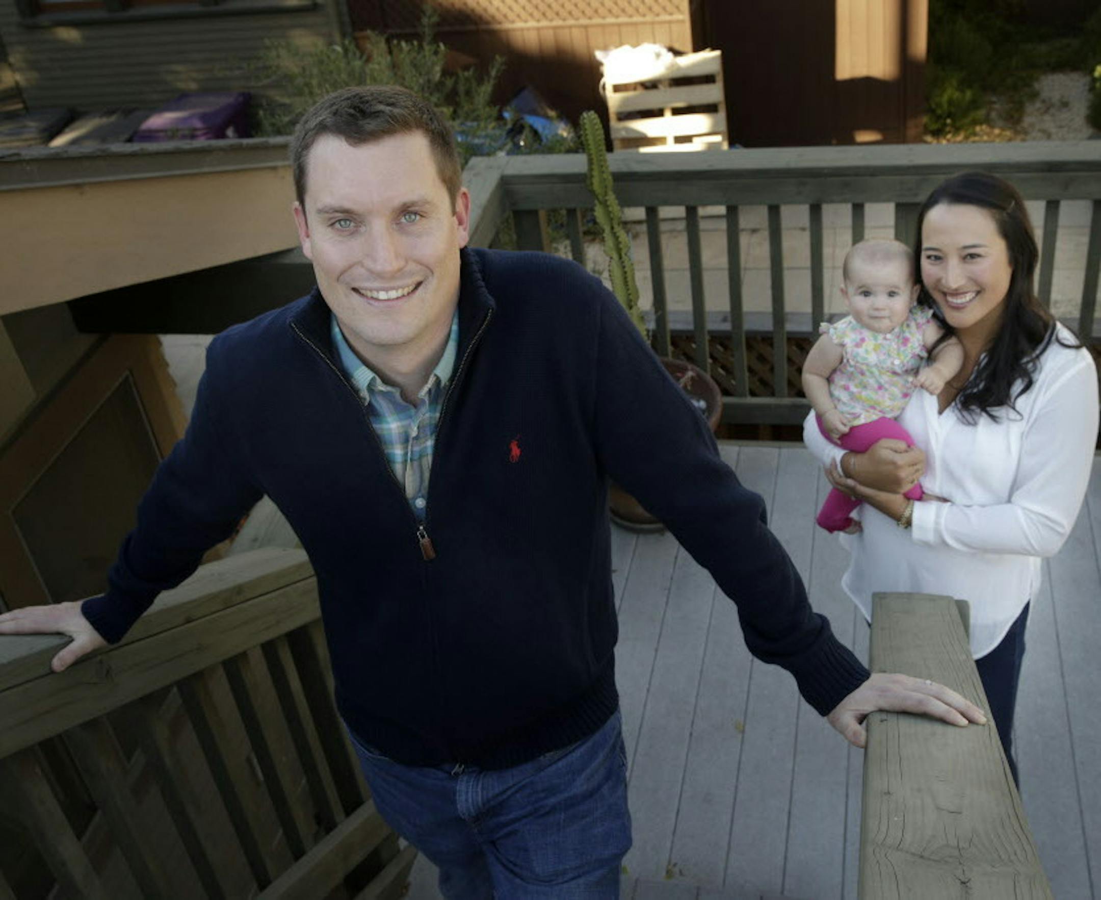 In this Friday, Oct. 30, 2015 photo, attorney John Hinman, foreground, pauses for photos with wife, Kristen, and daughter, Hattie Nee, in Long Beach, Calif. Hinman has no choice but to work around 100 hours a week in the midst of a trial, leaving little time for his wife, Kristen, and their 7-month-old daughter. Even when heís not on a trial, he can put in 60 hours. (AP Photo/Jae C. Hong)