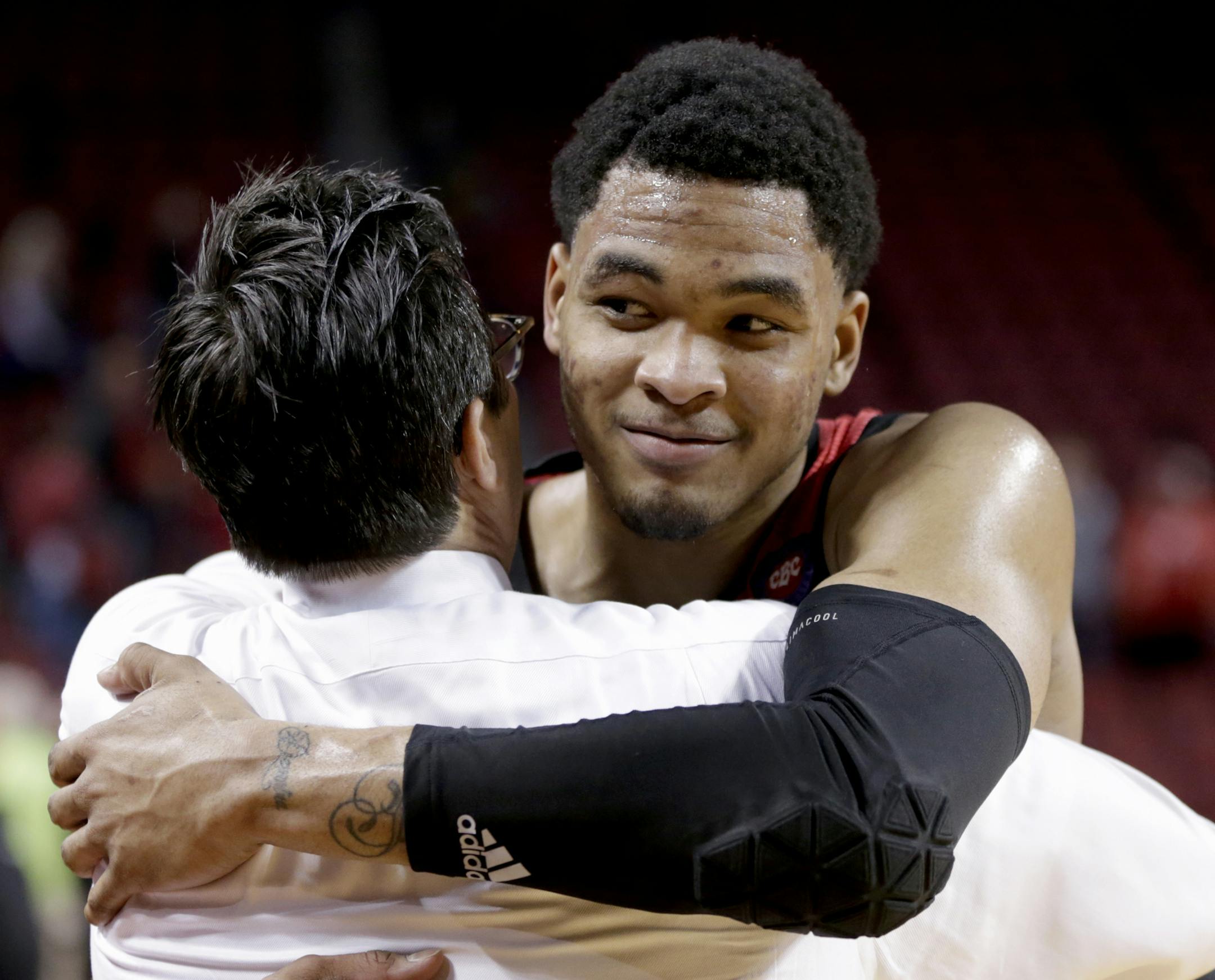 Nebraska's James Palmer Jr., right, hugs coach Tim Miles following an NCAA college basketball game against Minnesota in Lincoln, Neb., Wednesday, Feb. 13, 2019. Palmer made two free throws with 1.1 seconds left to give Nebraska a 62-61 win over Minnesota, ending the Cornhuskers’ seven-game losing streak. (AP Photo/Nati Harnik)