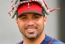 Minnesota Twins starting pitcher Hector Santiago (53) wore his glove on his head as he walked out to the backfields for a warmup Thursday at the start