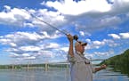 With the new St. Croix River bridge in the background, fly fisherman Bob Nasby prepared to shoot a surface bait &#x2014; a &#x201c;popper&#x2019;&#x20