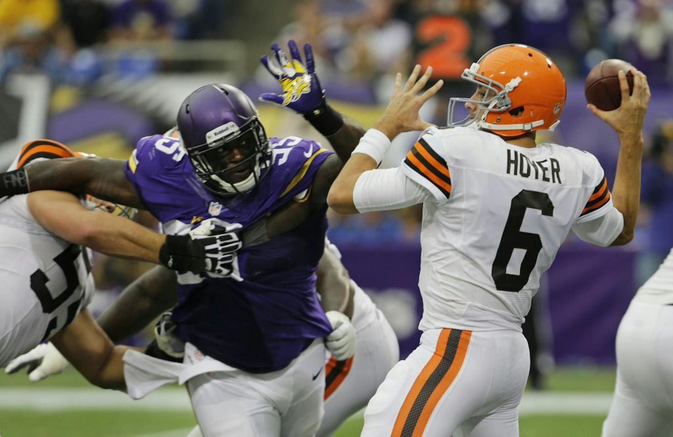 Cleveland Browns quarterback Brian Hoyer (6) passes the ball while getting pressured by Minnesota Vikings defensive tackle Sharrif Floyd during the second half of an NFL football game Sunday, Sept. 22, 2013, in Minneapolis.