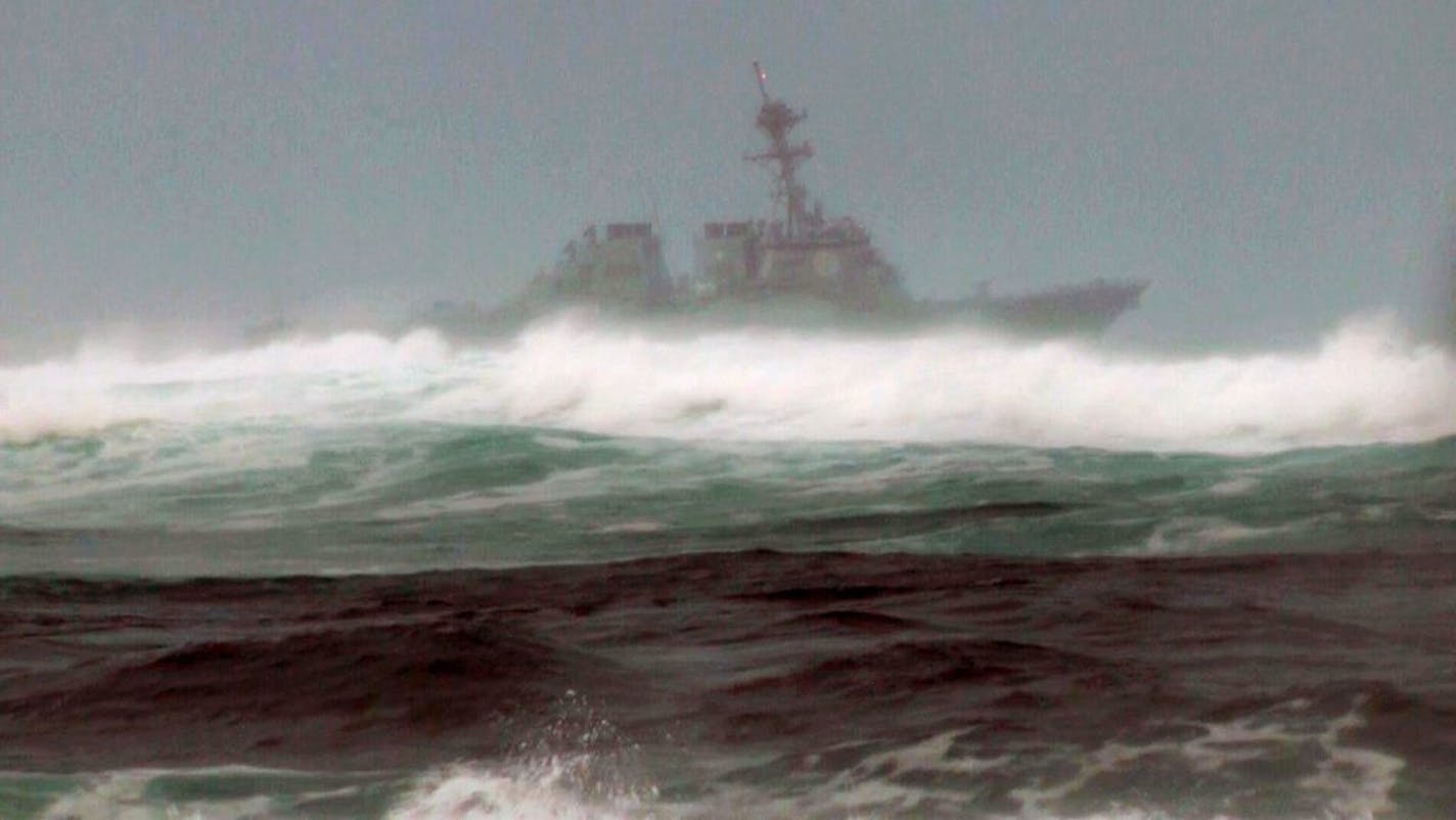 RETRANSMIT FOR IMPROVED TONING - A search vessel cruises the waters off the beach at Haleiwa, Hawaii, Friday, Jan. 15, 2016. Two Marine helicopters carrying 12 crew members collided off the island of Oahu during a nighttime training mission, and rescuers are searching a debris field in choppy waters, military officials said.