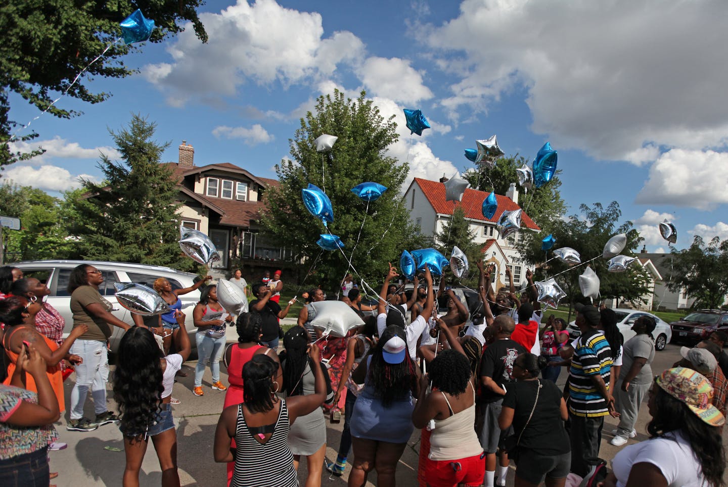 A group releases balloons into the air during a vigil for 28-year old Jaquan Oatis who was shot and killed in the Jordan neighborhood in north Minneapolis before midnight on Friday, August 12, 2016. Oatis&#xed; death was the city&#xed;s third homicide of the week and the 21st of the year. ] A vigil and memorial went up on the 2900 block of Morgan Avenue in north Minneapolis on Saturday, August 13, 2016. Shari L. Gross / Star Tribune sgross@startribune.com