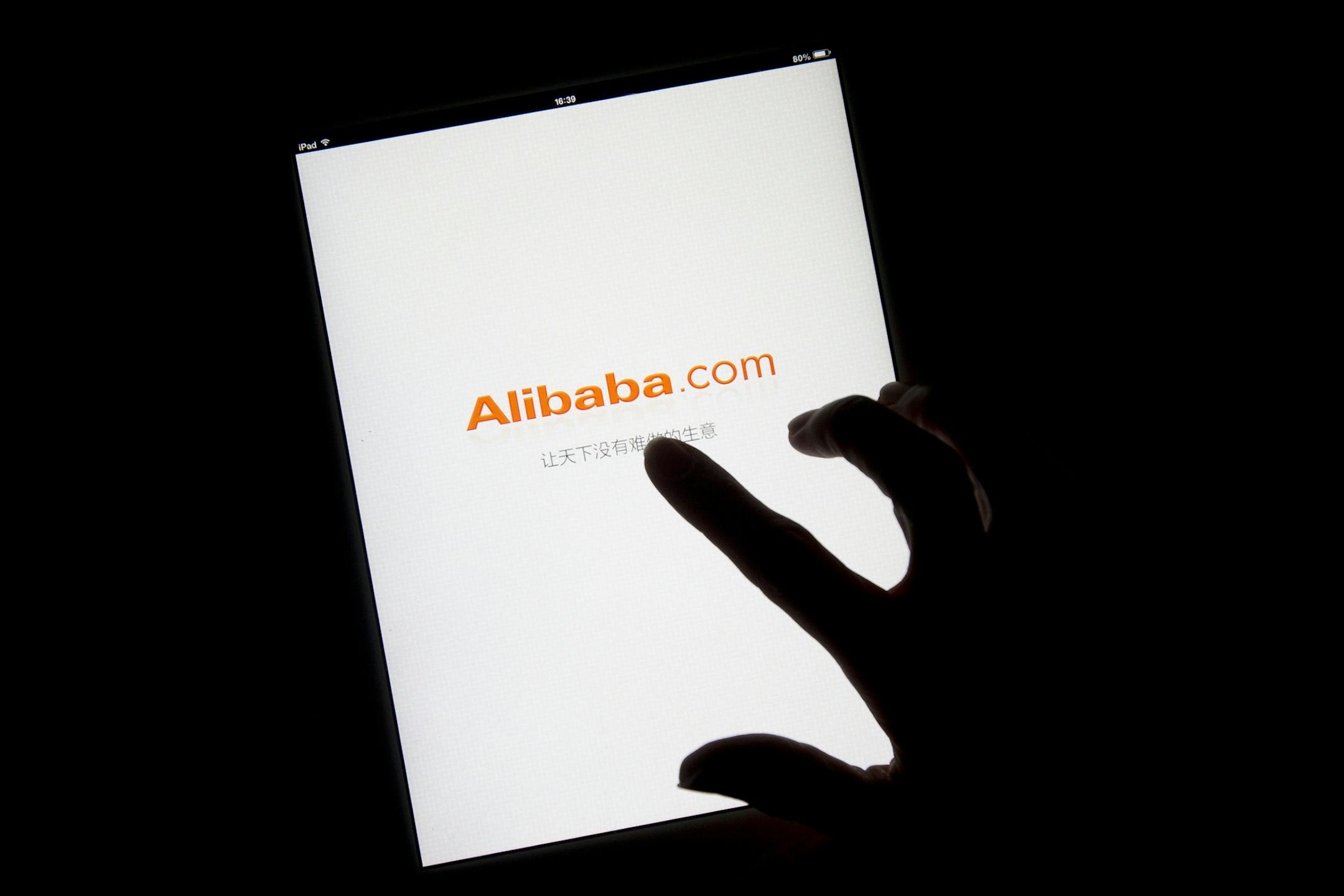 FILE PHOTO: The Alibaba Group Holding Ltd. logo is displayed on an app loading page on an Apple Inc. iPad in this arranged photograph in Hong Kong, China, on Sunday, April 20, 2014. Alibaba, which rode China's emergence as an economic superpower over the last 15 years to become a massive online marketplace for everything from forks to forklifts, filed today for what could become the largest U.S. initial public offering ever. Photographer: Brent Lewin/Bloomberg ORG XMIT: 488897207