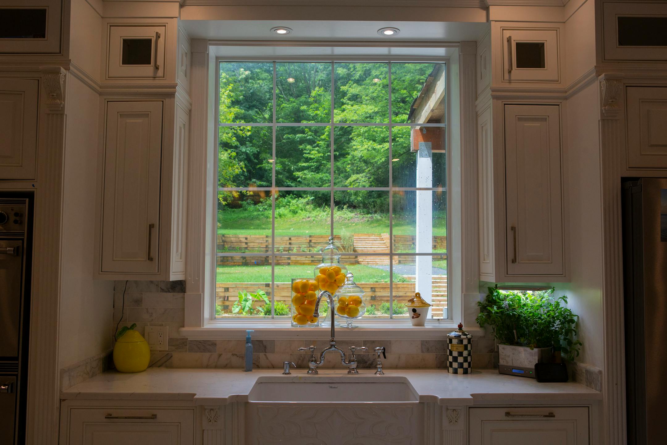 The fireclay kitchen sink features an embossed apron front and a bridge faucet. Photographed July 9, 2021, in Oyster Bay, N.Y. MUST CREDIT: Photo for The Washington Post by Calla Kessler