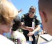 Brooklyn Park police officer Josh White handed out &#x201c;cop&#x201d;sicles to kids during the Brooklyn Park Recreation Summer Camp Culture Fair.