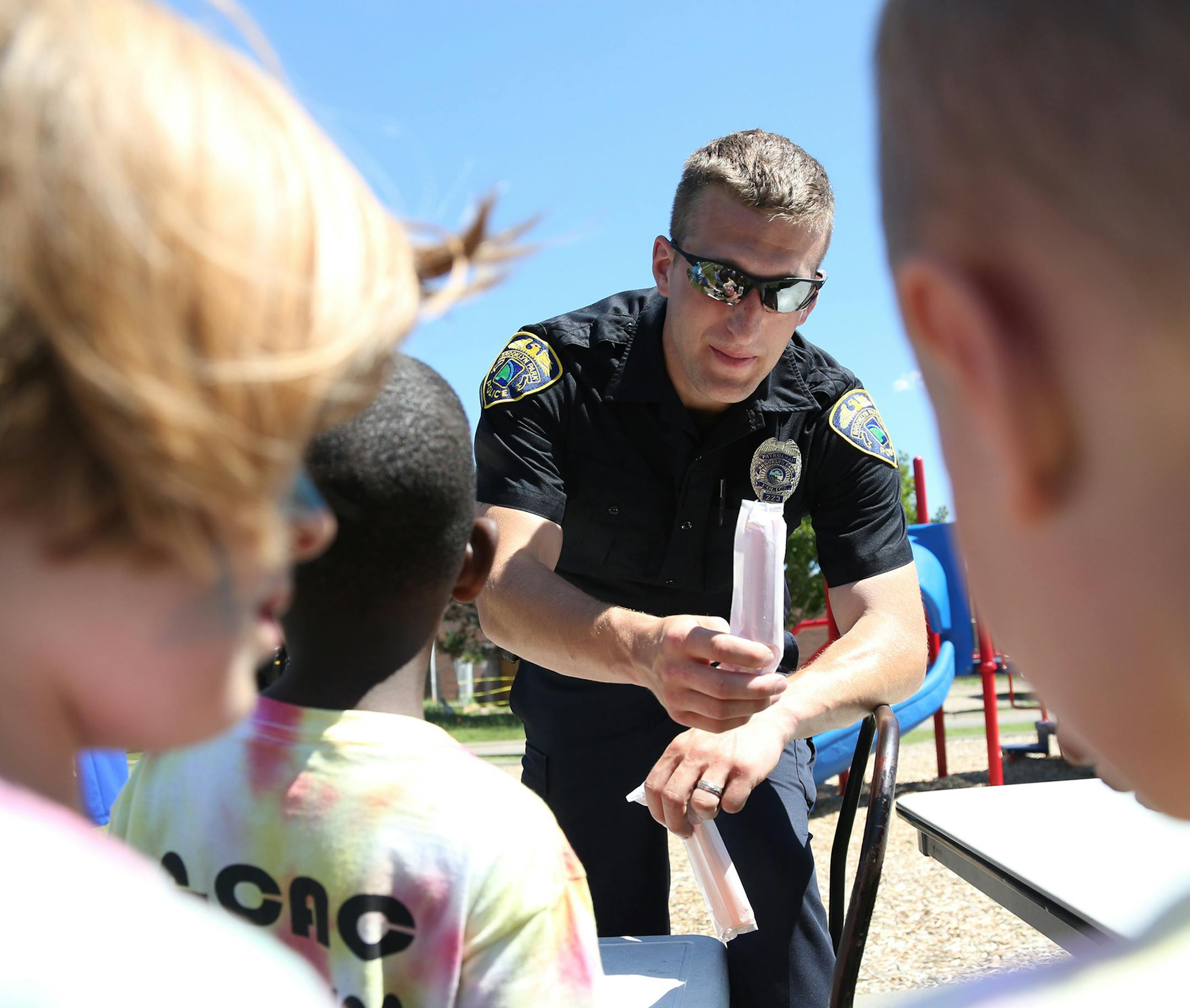 Brooklyn Park police officer Josh White handed out “cop”sicles to kids during the Brooklyn Park Recreation Summer Camp Culture Fair.