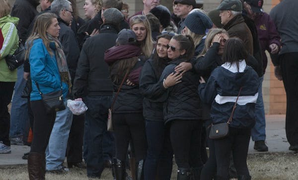 Friends and family shared hugs during a vigil for missing University of Minnesota student Jennifer Houle on Sunday at Stillwater Area High School.