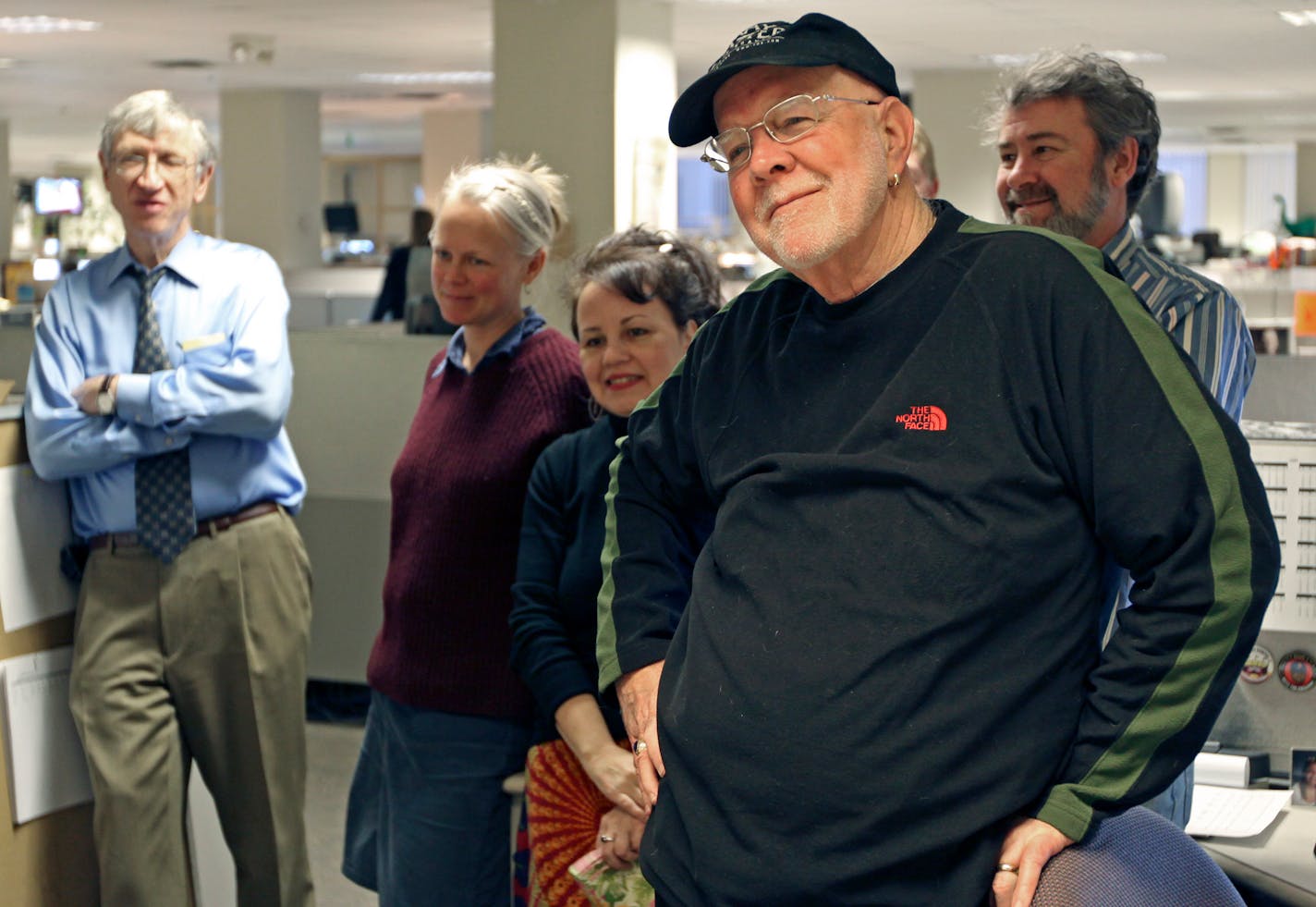 (right) Bud Armstrong listened to members of the sports department and the news room say good-by, during a department send-off of the long time Star Tribune employee.