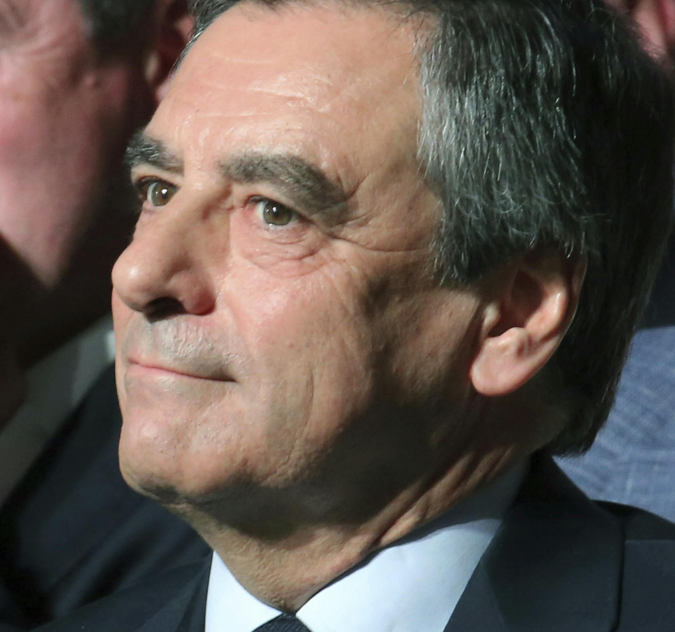 FILE - In this April 9, 2017 file photo, Conservative French presidential candidate Francois Fillon and his wife Penelope attend a campaign meeting in Paris. Conservative candidate Francois Fillon is struggling to keep his chances in the presidential election despite a personal image damaged by corruption allegations. Once a front-runner in the race, Fillon's campaign has been flailing since the investigation began in January. (AP Photo/Thibault Camus, File)