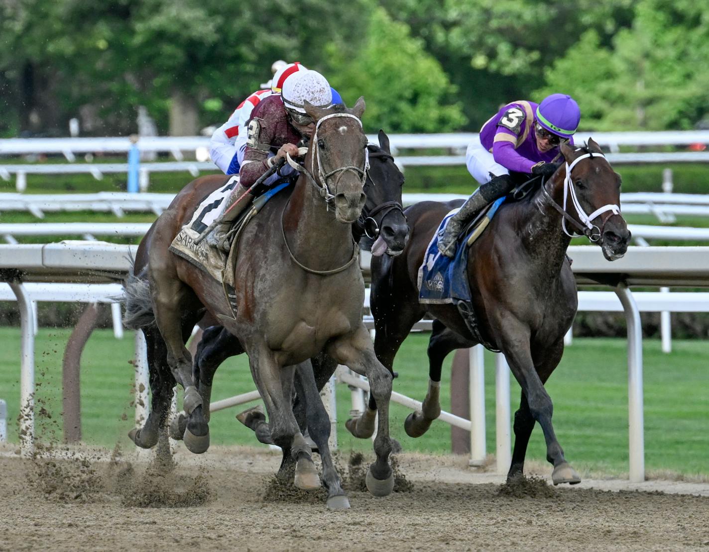 Epicenter, left, with jockey Joel Rosario, edges away from Tawny Port, right, and Zandon down the stretch in the in the Jim Dandy Stakes at Saratoga Race Course in Saratoga Springs on Saturday