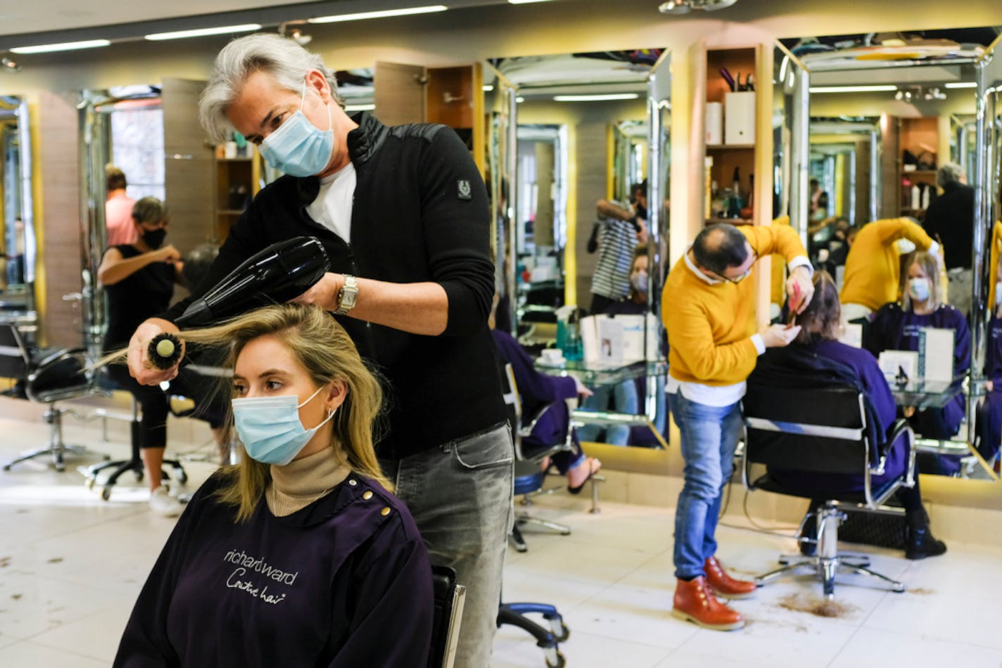 Richard Ward, owner of Richard Ward Hair & MetroSpa, wore a protective face mask as he worked in his salon in London on Nov. 4.