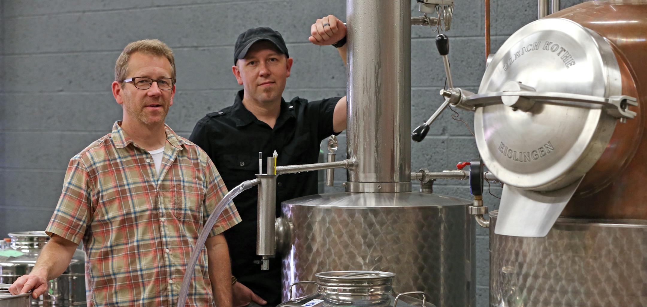 (left to right) Robert McManus and Lee Egbert of 11 Wells Distillery were photographed in the distillery room on 6/28/14. The old Hamm's brewery building is getting back in the booze game, with 11 Wells Distillery and Flat Earth Brewing now up and running -- "Hamm's building brews anew."] Bruce Bisping/Star Tribune bbisping@startribune.com Robert McManus, Lee Egbert/source.