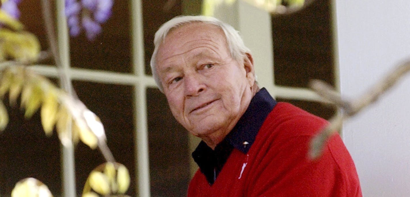 FILE--This 2004 file photo shows former Masters champion Arnold Palmer as he sits on clubhouse railing at the Augusta National Golf Club in Augusta, Ga. Palmer, who made golf popular for the masses with his hard-charging style, incomparable charisma and a personal touch that made him known throughout the golf world as "The King," died Sunday, Sept. 25, 2016, in Pittsburgh. He was 87. (AP Photo/David J. Phillip, File) ORG XMIT: MIN2016092611324809