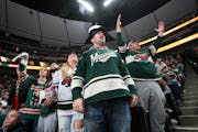 Minnesota Wild fans, including Kris Fay, center and his wife Katie, of Albany, Minn., are upset with officials during the second period against the Ne