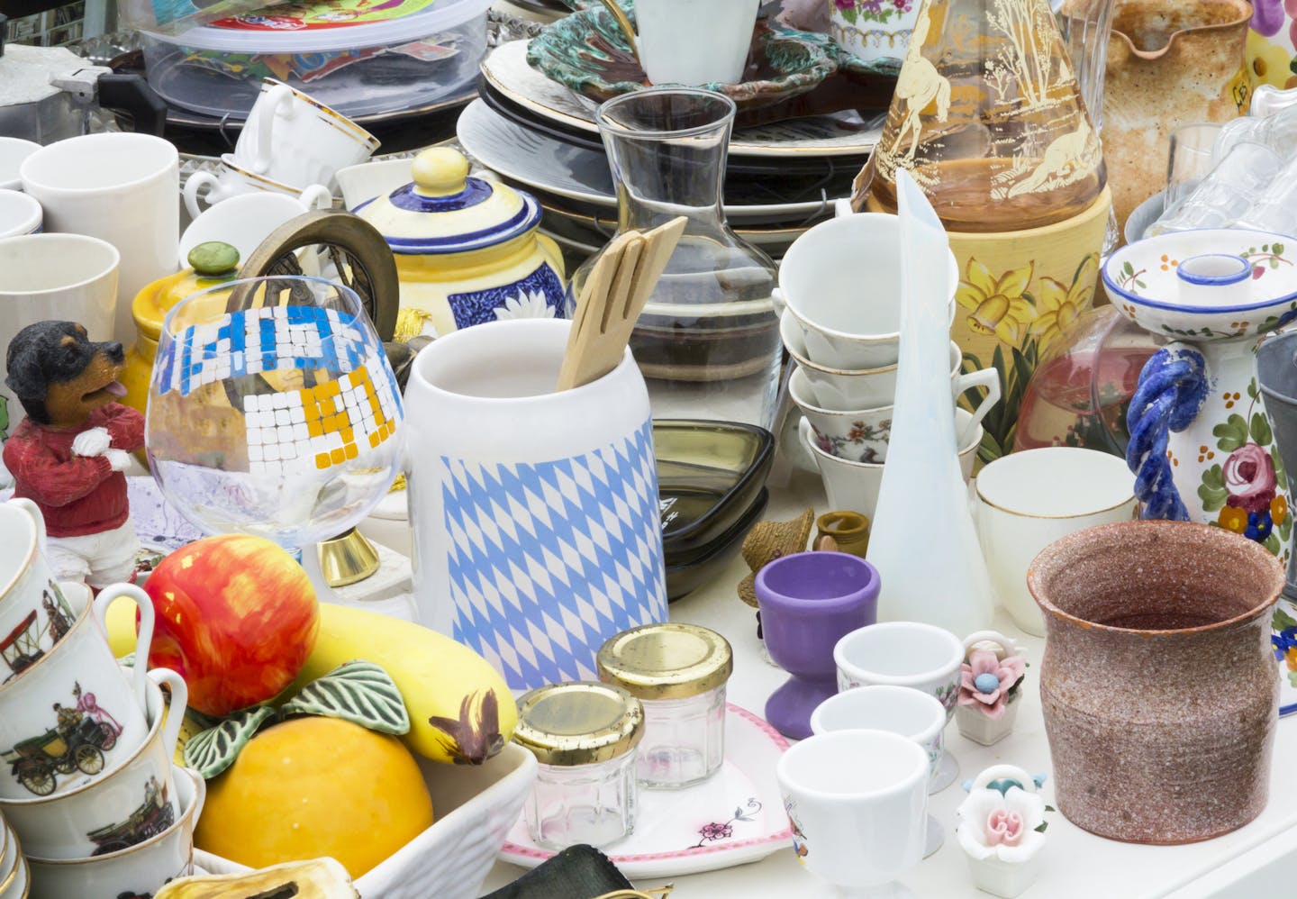 Outdoor Flea market in France with toys, table ware, coffee cups, plates and glasses