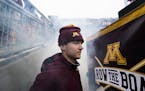 Minnesota Gophers punter Casey O'Brien (14) watched his team take the field. O'Brien is undergoing cancer treatment. ] MARK VANCLEAVE ¥ The Wisconsin