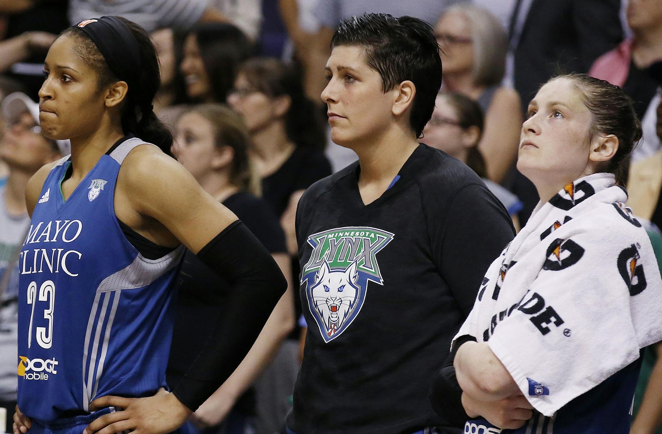 Minnesota Lynx's Maya Moore, Janel McCarville, and Lindsay Whalen, from left, watch the closing moments from the bench in Game 3 in the WNBA Western Conference basketball finals Tuesday, Sept. 2, 2014, in Phoenix. The Mercury defeated the Lynx 96-78, winning the series and advancing to the WNBA Finals. (AP Photo/Ross D. Franklin) ORG XMIT: MIN2014090412281026