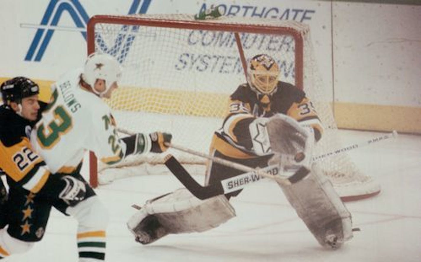 The North Stars' Brian Bellows, center, tried to get the puck past Pittsburgh Penguins goalie Tom Barrasso during the 1991 Stanley Cup Final.