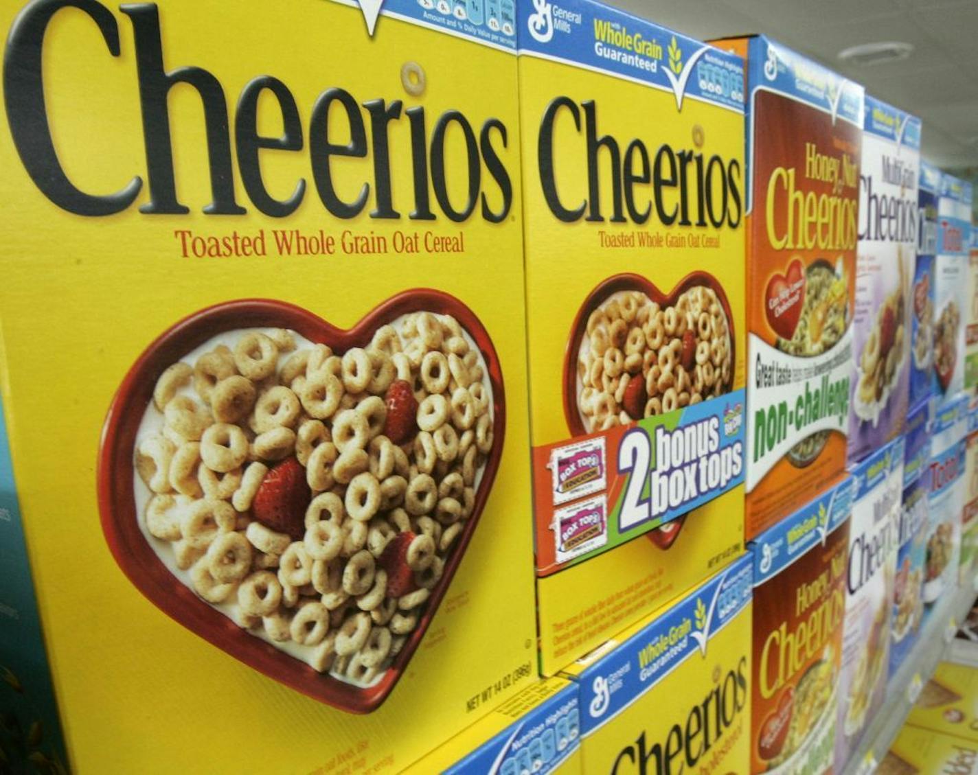 FILE - In this file photograph taken Sept. 10, 2009, boxes of General Mills Cheerios breakfast cereal varieties are displayed at a Little Rock, Ark., grocery store. The maker of Cheerios cereal, Yoplait yogurt and other food products said Wednesday, Sept. 22, 2010, better cereal and snack sales drove its fiscal first-quarter net income up 12 percent.