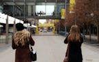 Two women stopped to photograph the empty street following dedication ceremony to mark the opening of the newly renovated Nicollet Mall Thursday. ] AN