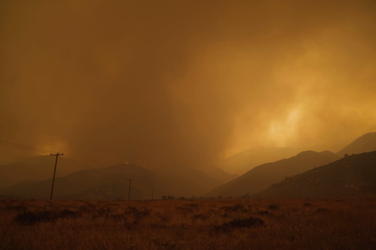 FILE — The Bobcat Fire burns in Juniper Hills, Calif., on Thursday, Sept. 17, 2020. A new study links air pollution from wildfire smoke to higher rates of coronavirus cases and deaths. (Eric Thayer/The New York Times)