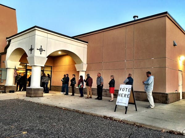 Voters wait in line Tuesday morning to cast their votes in the presidential election at St. George Antiochian Orthodox Church in West St. Paul.
